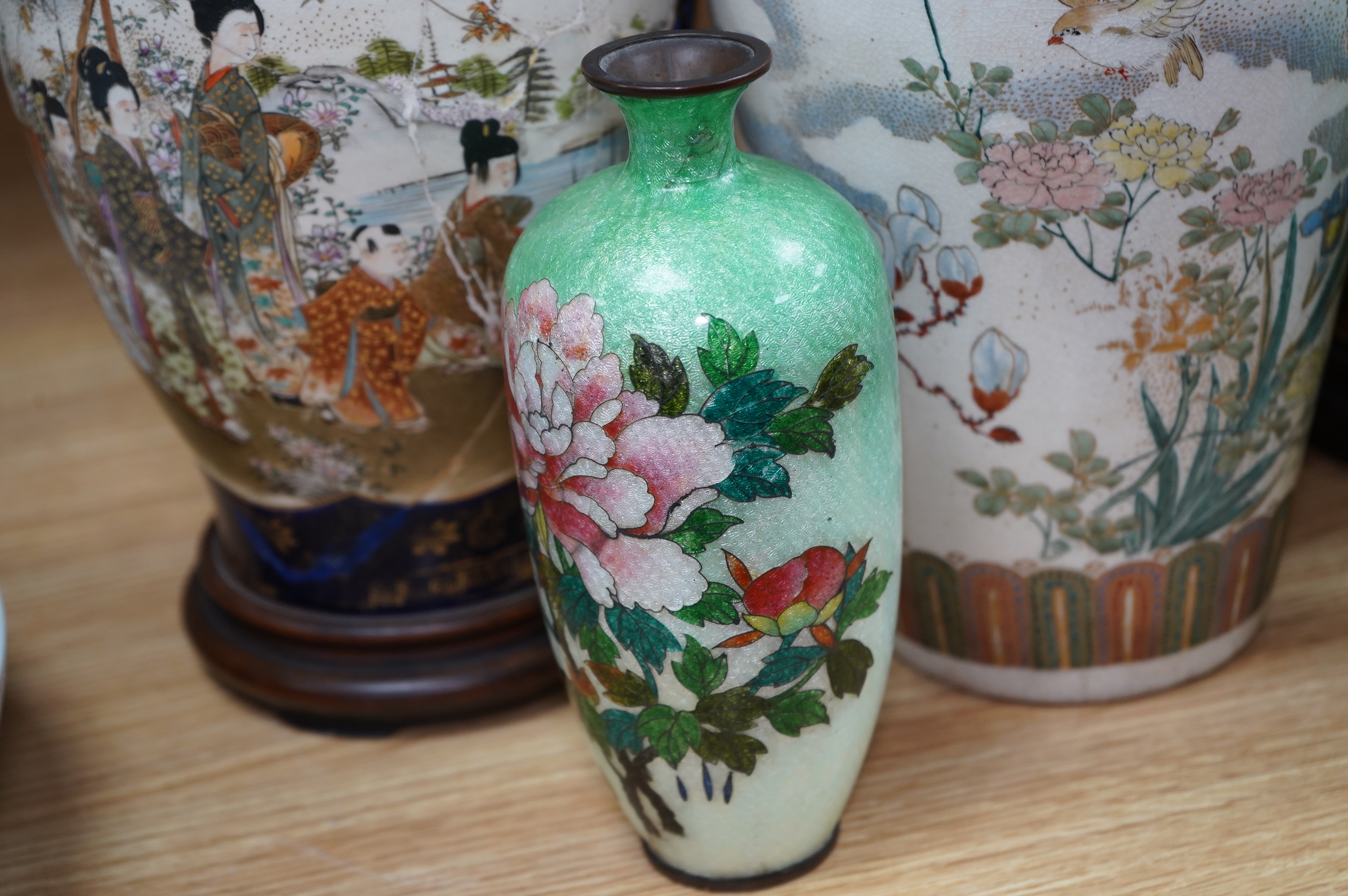 A pair of Japanese Satsuma vases on stands, a pair of floral enamel vases and another Satsuma pottery vase, largest 35cm high. Condition - poor